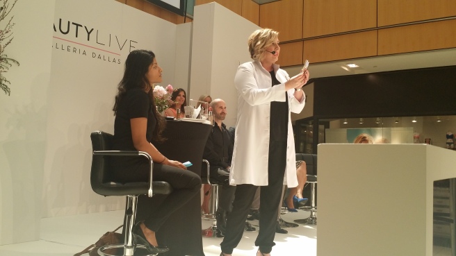 Clinique's regional education executive Lisa Boness does a makeover on a willing "victim" at the Belk panel.